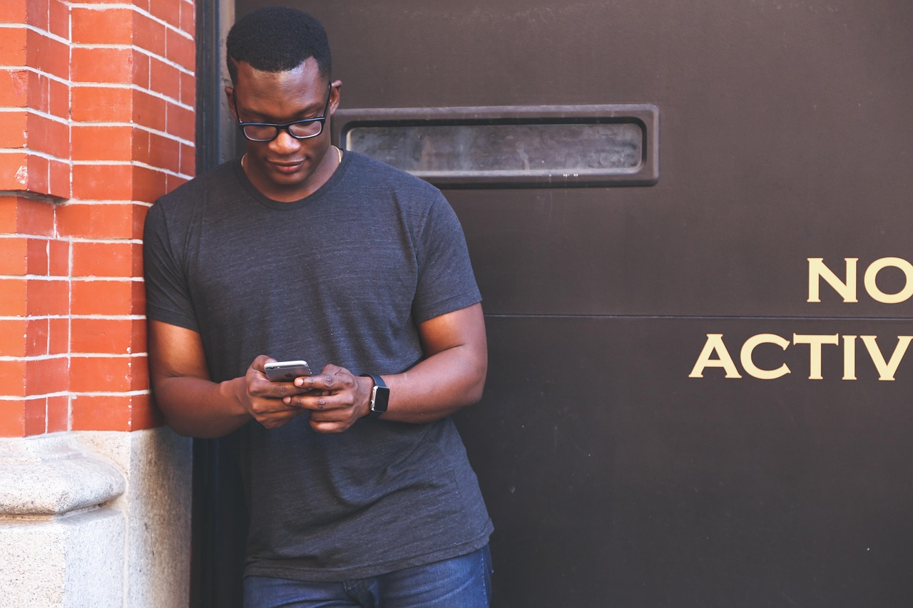 Hospitality worker looking at a smartphone in hand